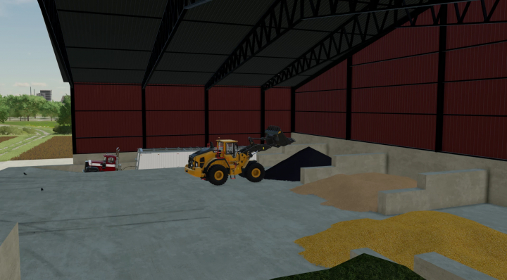 FS22 mods Commodity Building v1.0.0.0 showing large indoor storage with machinery and grain piles.