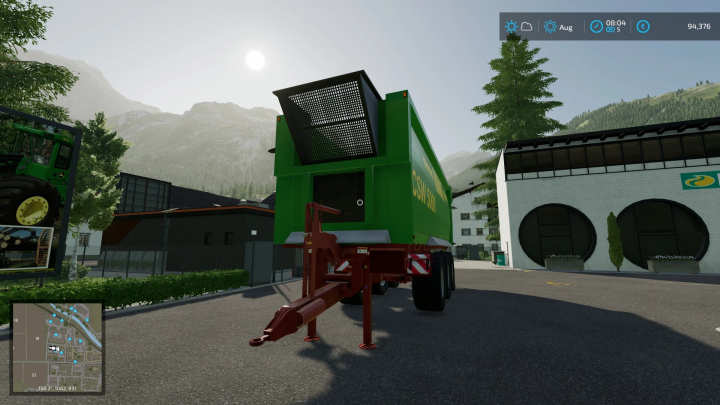 FS22 mod Hawe csw 5000 v2.0.0.0 rimorchio in Farming Simulator 22, parcheggiato vicino a edifici sotto un cielo limpido.