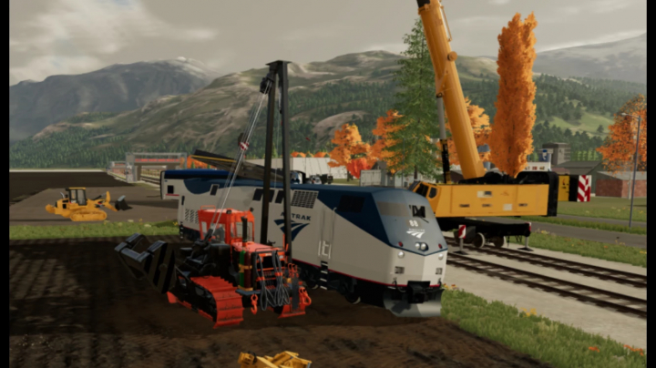 FS22 Kirow multitasker T1200 v1.4.0.0 mod mostrando construcción junto a un tren y grúa en un paisaje montañoso.