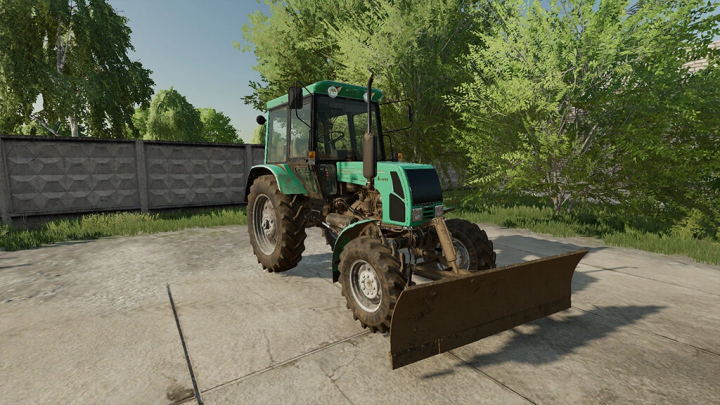 fs22-mods, FS22 mod Kiy-14102 v1.0.0.0, a green tractor with blade attachment, set on a concrete surface with lush green trees in the background.