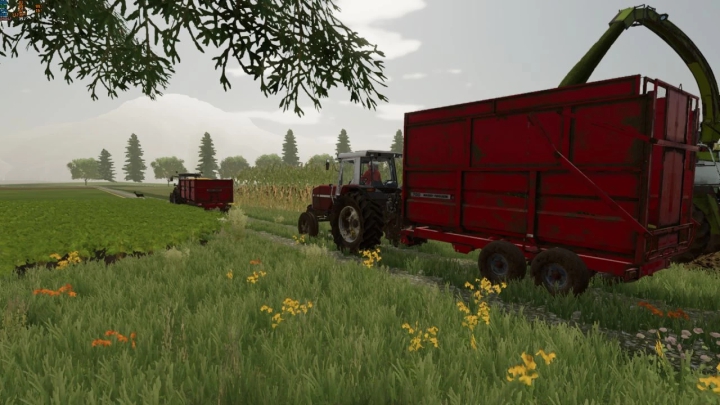 FS22-mod Massey Ferguson 700 tractor met rode trailer in weelderig boerenlandschap.