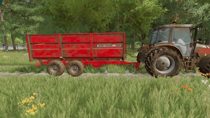 fs22-mods, FS22 mod Massey Ferguson 700 trailer attached to a tractor in a grassy field.