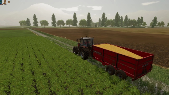 FS22 Massey Ferguson 700 mod trailer geladen met graan op een veld, Farming Simulator 22 mods.