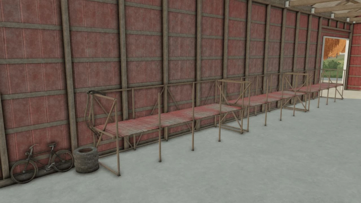 Interior of old school American barn in FS22 mod with wooden benches and bicycle.