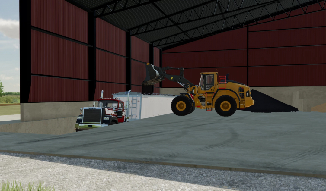 FS22 mods Commodity Building v1.0.0.0 montrant un chargeur déchargeant dans un camion dans un grand entrepôt.