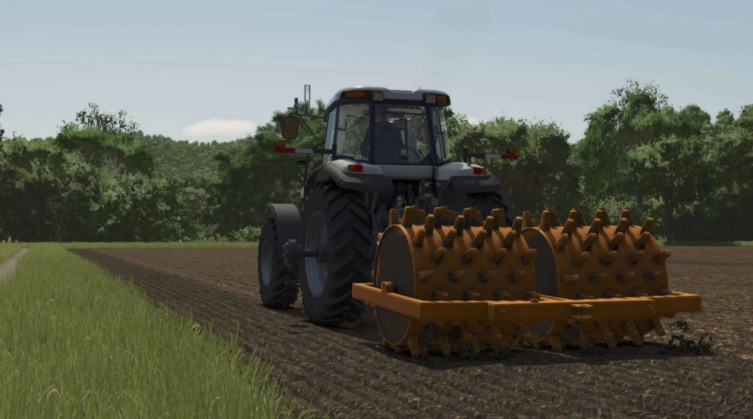 Tractor using Lizard Sheepsfoot Roller mod in FS25 to prepare soil.