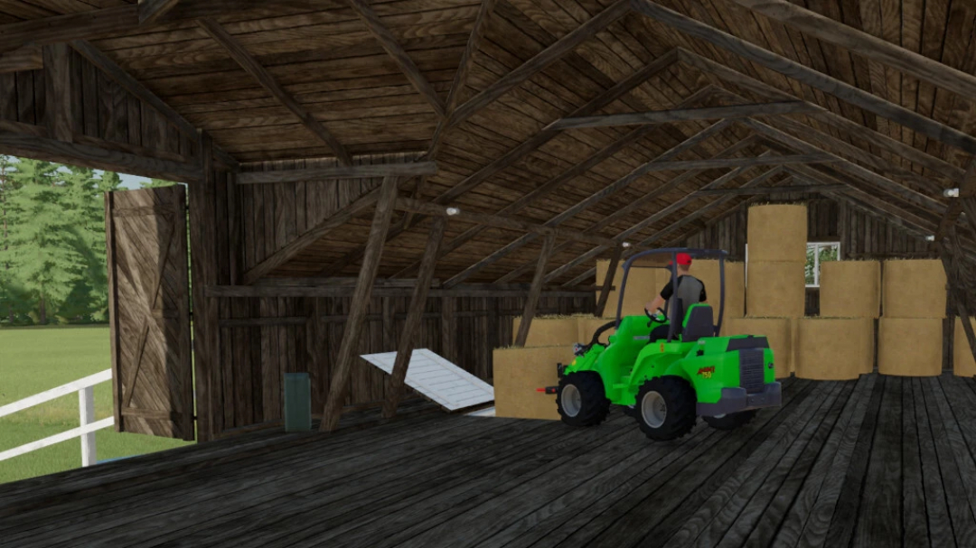 FS22 mod Old Brick Cow Barns: Interior with green tractor and hay bales