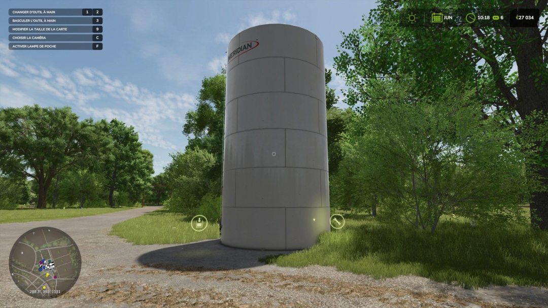 FS25 mods Silo Multifruits v1.0.0.0: A large storage silo surrounded by trees in Farming Simulator 25.