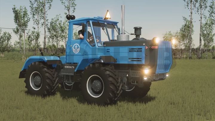 fs22-mods, Blue HTZ T-150K-09 tractor mod for FS22 in a grassy field, showcasing detailed machinery.