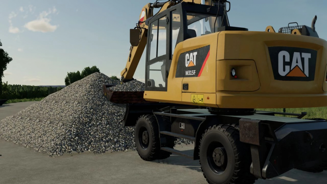 Caterpillar M315F excavator from FS22 mod lifting gravel on a sunny day.