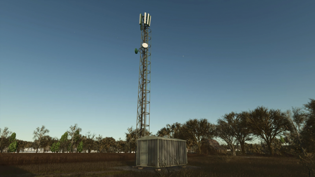 Mod FS25 Antena Celular v1.0.0.0 em um campo, mostrando uma torre de telecomunicações alta ao lado de um pequeno prédio.