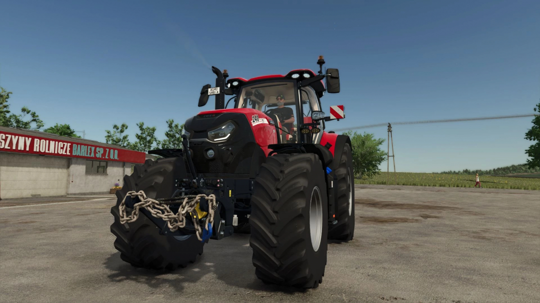 FS25 mod Chains and Cables v1.0.0.0 featuring a red tractor with chains on the front, in a farming environment.