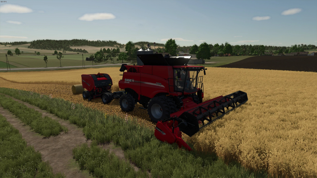 FS25 mod: Red combine harvester in a field with a baler attachment, highlighting Dolly Extended v1.0.0.0.