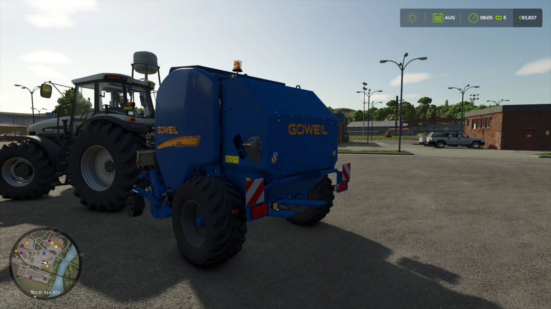 Goeweil F125 Edited mod in FS25, showing a blue baler attached to a tractor in a parking area.