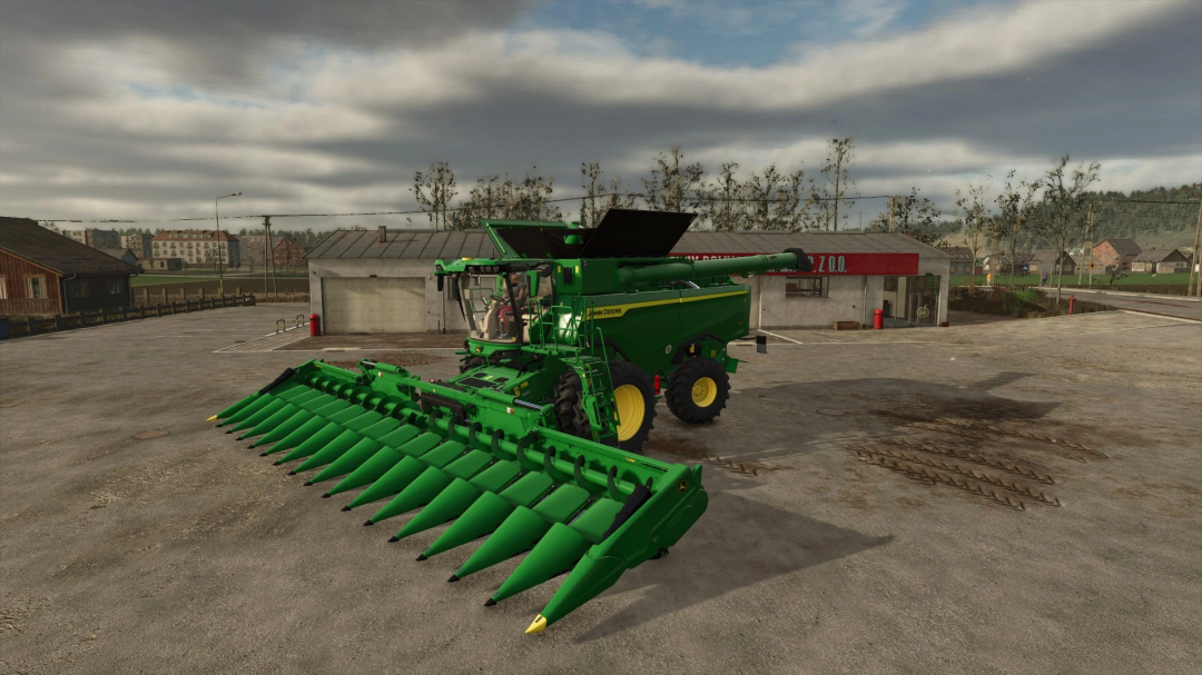 John Deere 7S Series harvester mod in FS25 with green headers, parked in a farmyard.