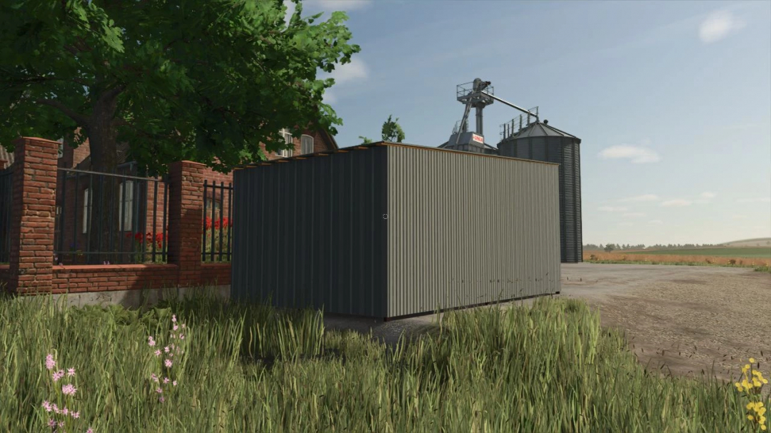 Garage in metallo nel pacchetto mod FS25, circondata da erba e strutture agricole in Farming Simulator 25.