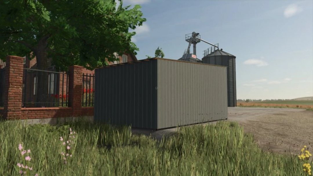 Metal garage in FS25 mod, Metal Garages Pack v1.0.0.0, surrounded by grass, with farm buildings in the background.