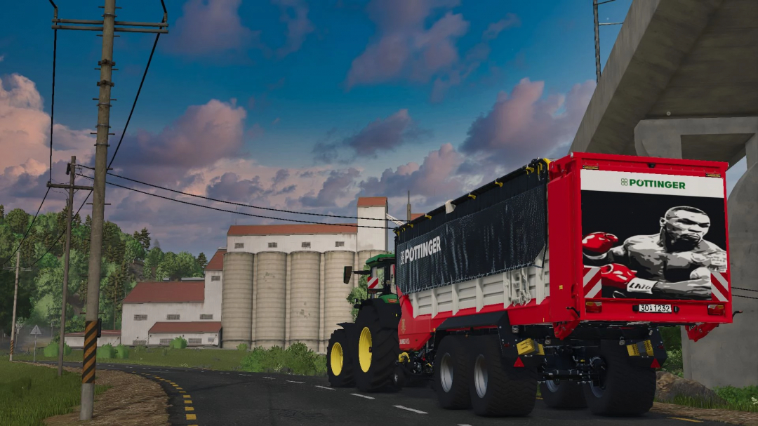 Poettinger Jumbo 8450DB Iron Mike Edition mod in FS25, featuring a detailed farm setting with silos.