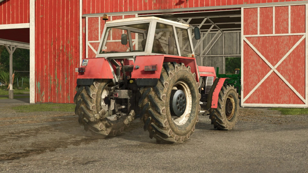 Mod de tractor Zetor Crystal 16045 en Farming Simulator 25 cerca de un granero rojo.