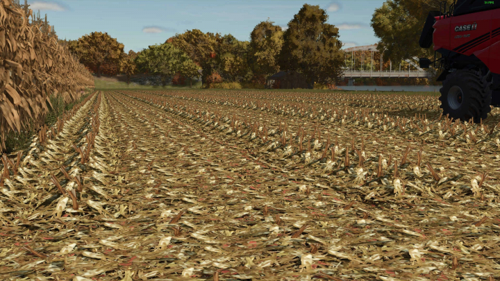 fs25-mods,  Cornfield with detailed trash textures in FS25 mods, featuring autumn trees and machinery. Farming Simulator 25 mod Corn trash textures v1.0.0.0.