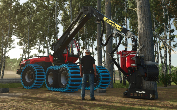 fs25-mods,  Komatsu 951 harvester in action in FS25 mod, featuring a person standing next to it in a forest setting.