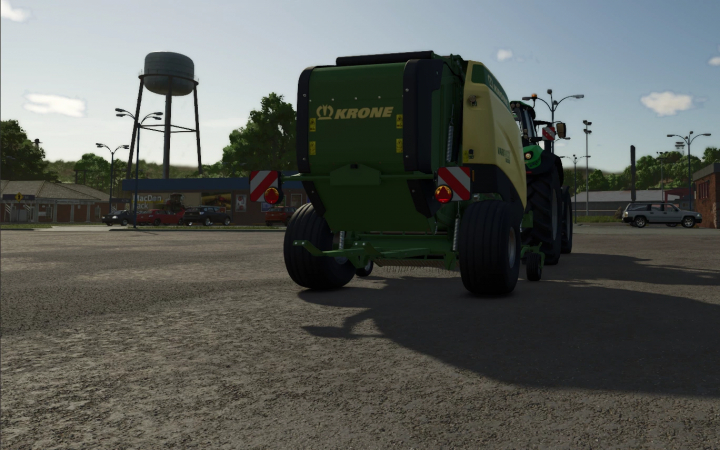 fs25-mods, Krone VariPack V190XC baler with floaters in FS25 mod, parked near a water tower.