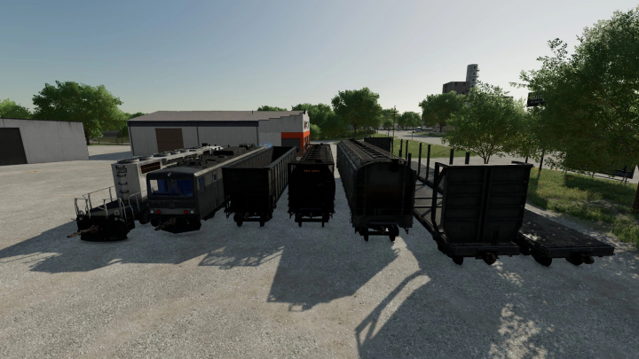 fs22-mods, FS22 Lizard Train Pack v1.0.0.0 featuring various train cars displayed in a yard. Farming Simulator 22 mods.