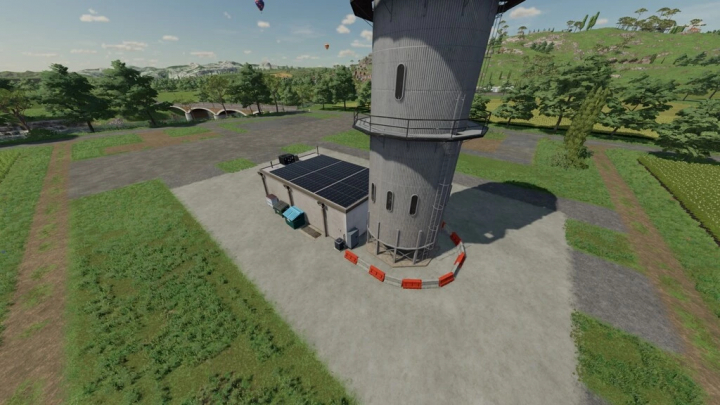 fs22-mods, FS22 mod Processing Of Bales And Chaff v1.0.0.0 featuring a tall silo and building on a farm, surrounded by greenery.