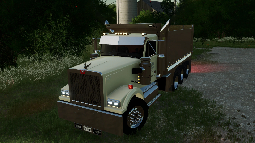 FS22 mod: 1990 Western Star 4964 Tri-Axle truck on a farm road, featuring realistic details in Farming Simulator 22.