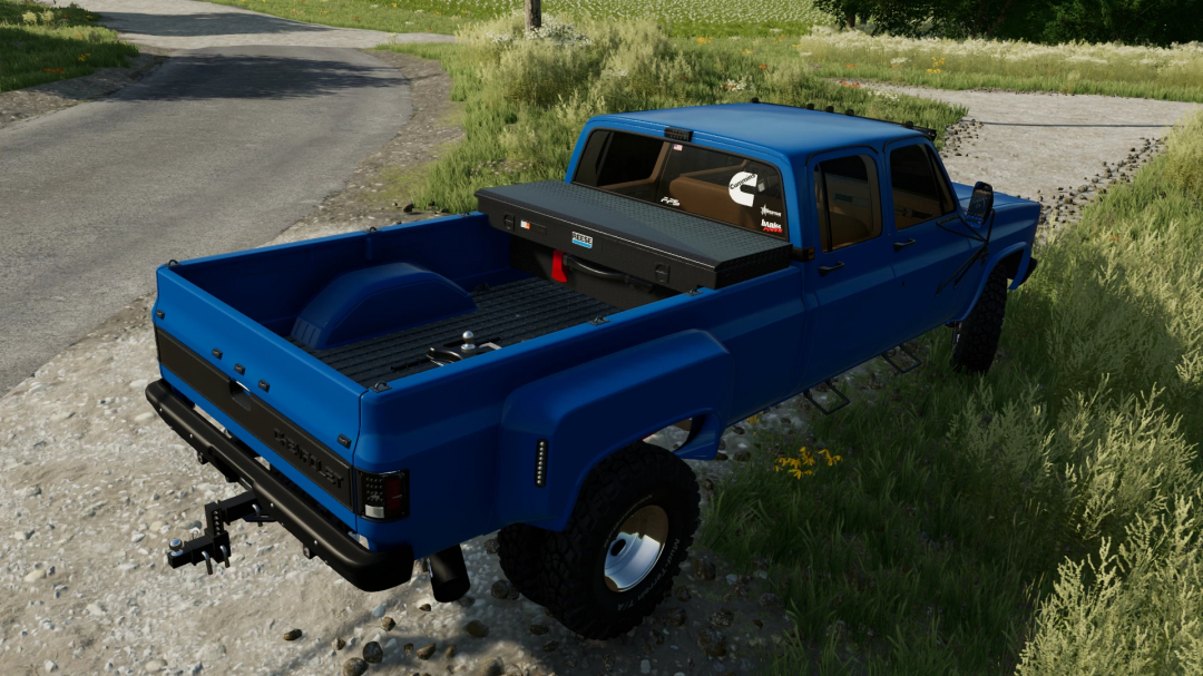 Chevrolet K30 Dually mod in FS22, showcasing a blue pickup truck on a grassy path. Farming Simulator 22 mods enhance gameplay realism.