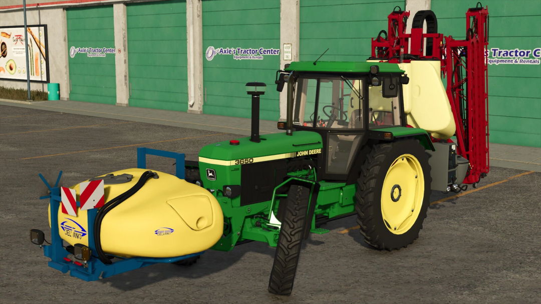 FS25 Fronttank 1100L Delvano mod v1.0.0.0 podłączony do zielonego ciągnika na parkingu.