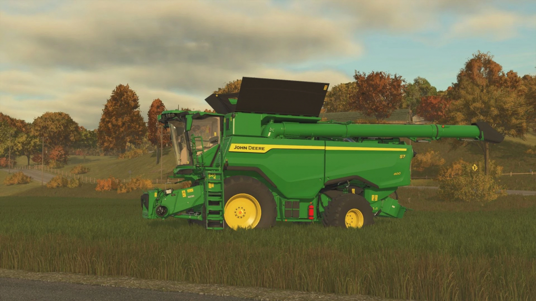 Colheitadeira John Deere S7 no mod FS25 com configurações de pneus em campo gramado, cenário de outono.