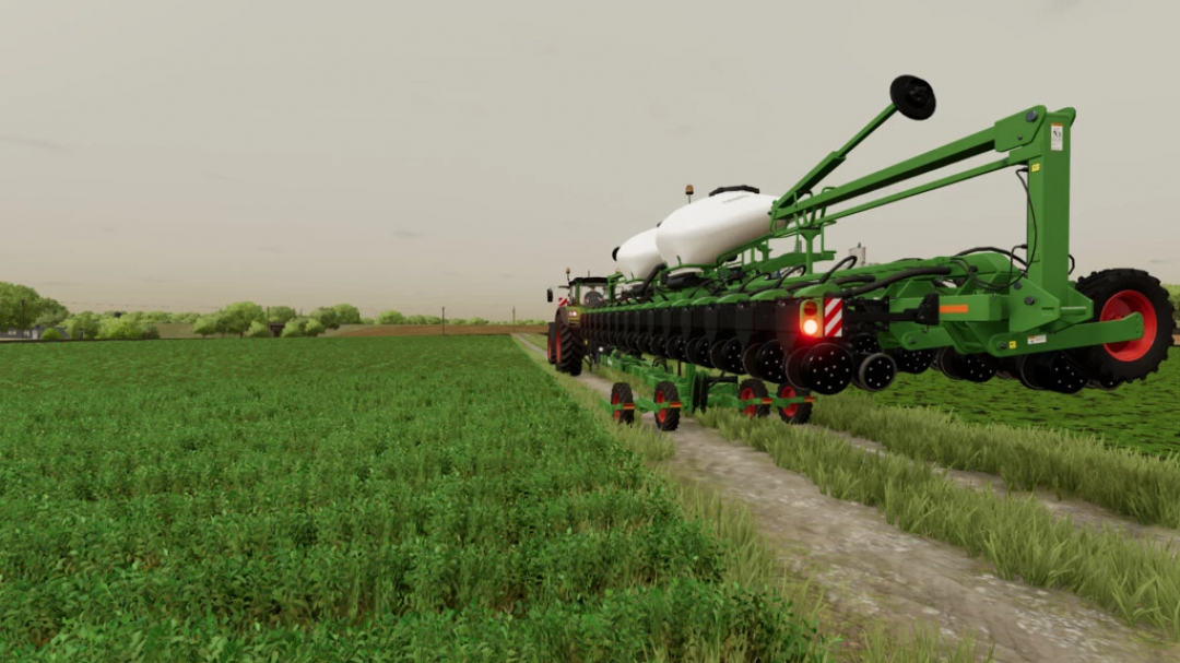 FS22 mod Kinze Multi-Fruit Planter Pack v1.2.0.0 in a farm field, showcasing detailed farming equipment.