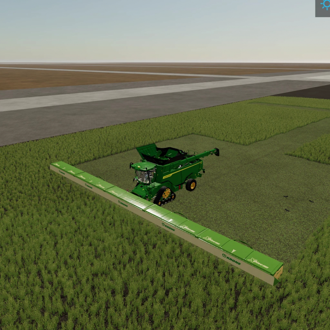 Krone xDisc62 1.0 mod in FS25 mowing a field, showing a green harvester with an extended cutting deck.