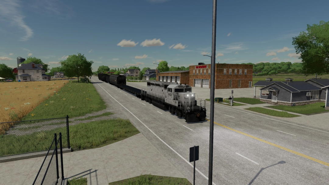 FS22 Lizard Train Pack v1.0.0.0 mod z pociągiem towarowym na wiejskiej drodze z wiejskim krajobrazem.