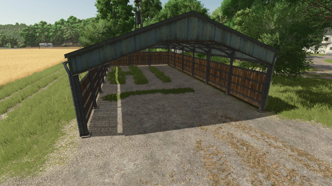 FS25-Mod Paint And Terraform Anywhere zeigt einen rustikalen Unterstand auf einem Bauernhof mit Gras- und Kiesboden.