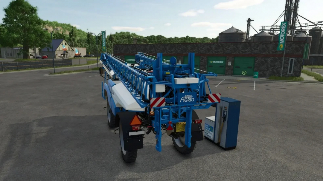 FS25 mod showing a pump for silage additive, liquid fertilizer, herbicide by a vehicle in front of Motorex building.