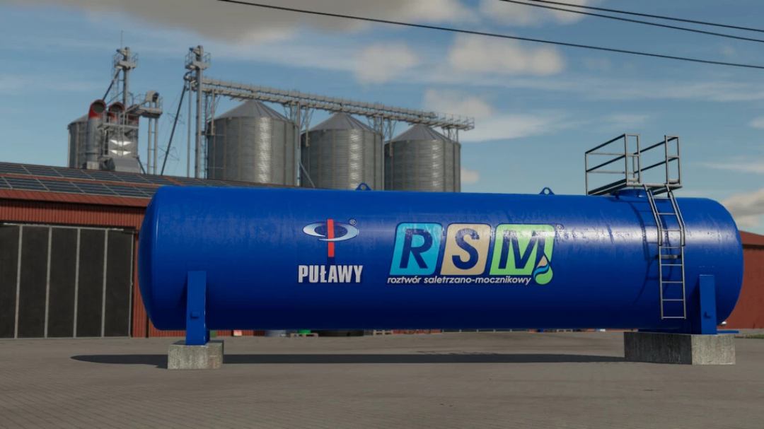 Mod FS22 RSM Container v1.0.0.0 przedstawia duży niebieski zbiornik przemysłowy z silosami rolniczymi w tle.