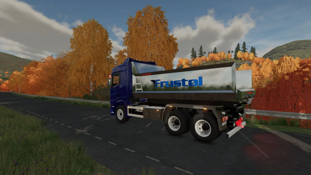 Ciężarówka FS22 Scania R Series Pack na drodze z jesiennymi drzewami w modzie Farming Simulator 22.