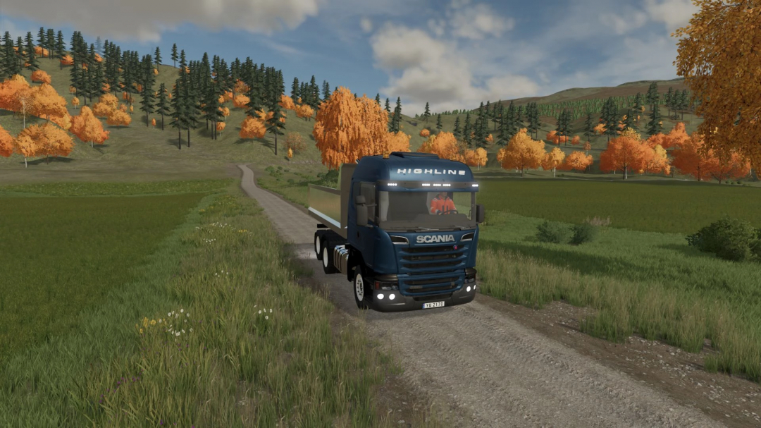 Ciężarówka Scania R Series na wiejskiej drodze w FS22 z jesiennymi drzewami.