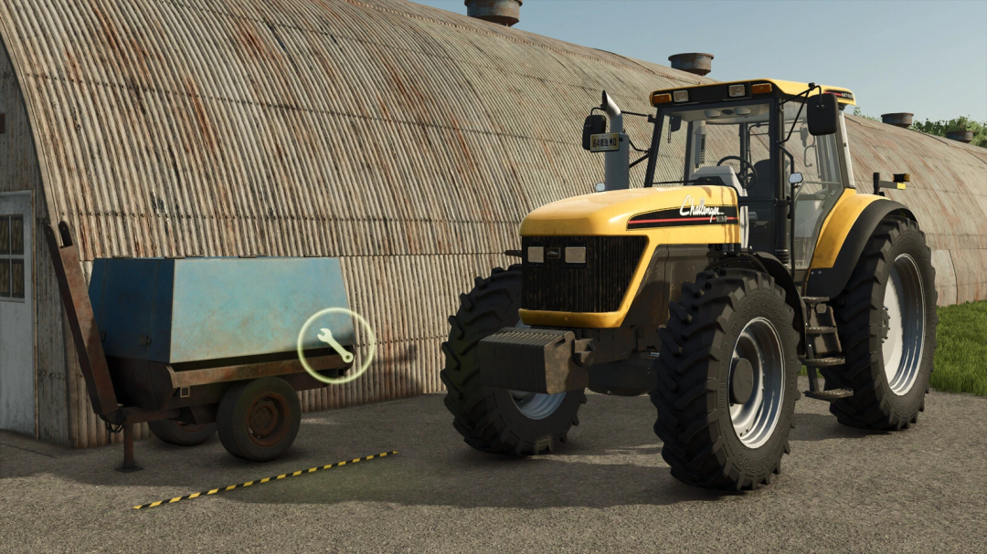 Een gele tractor naast een kleine stationaire werkplaatsaanhanger in FS25-mods.