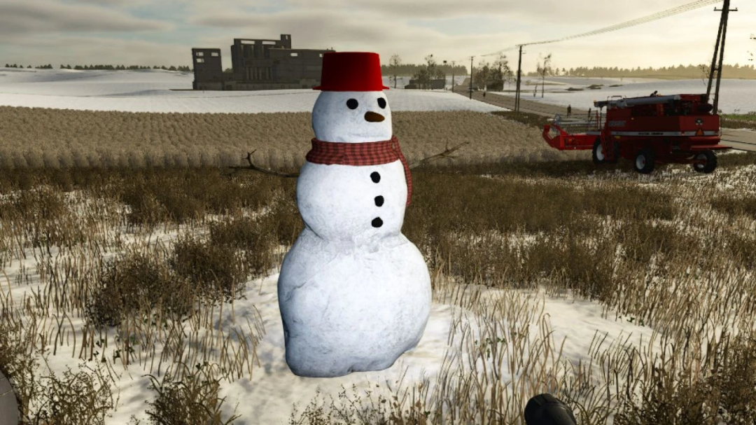 FS25 Mod Snowman v1.0.0.0 in einem verschneiten Farming Simulator 25 Feld, mit rotem Mähdrescher im Hintergrund.