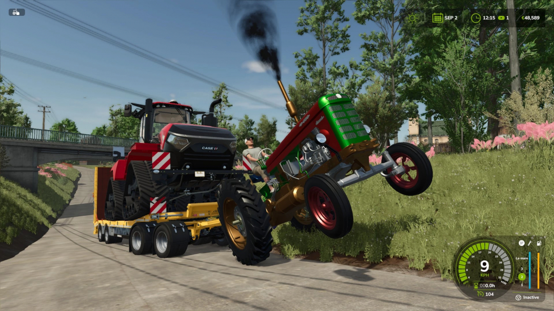 UTB 650 Turbo mod for Farming Simulator 25 performing a wheelie next to a trailer carrying a tractor.