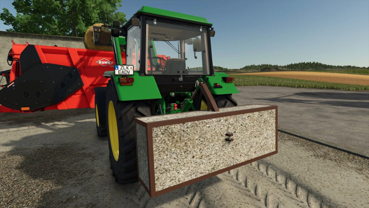 fs25-mods,  FS25 mod: Green tractor with Artisanal Weight v1.0.0.0 attached, beside red farming equipment.