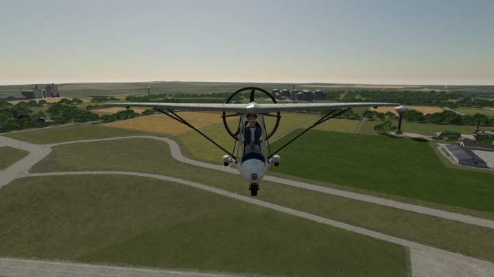 fs22-mods,  FS22 mod ULA71084 features a small aircraft flying over a farm landscape in Farming Simulator 22. Enhances gameplay realism.