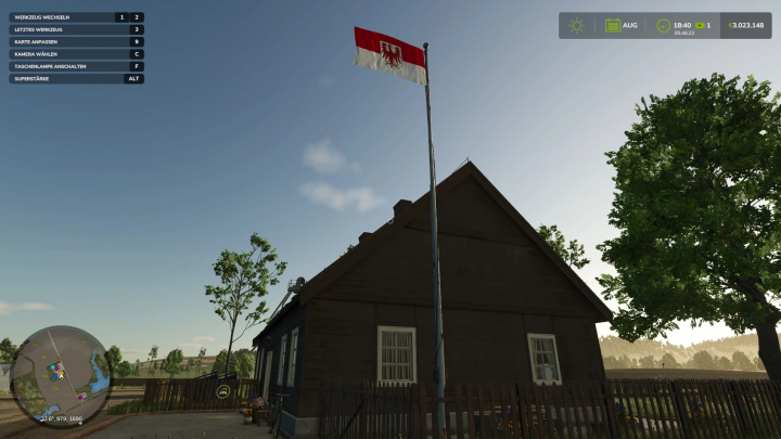 fs25-mods,  FS25-Mod zeigt die Flagge von Brandenburg neben einem rustikalen Haus unter klarem Himmel.