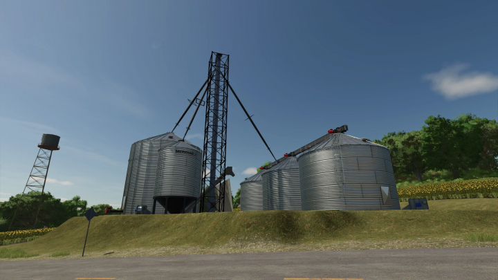 fs25-mods,  FS25 mods: Medium Grain Leg setup v1.0.0.0 featuring multiple large silos under a clear sky, enhancing storage options in Farming Simulator 25.