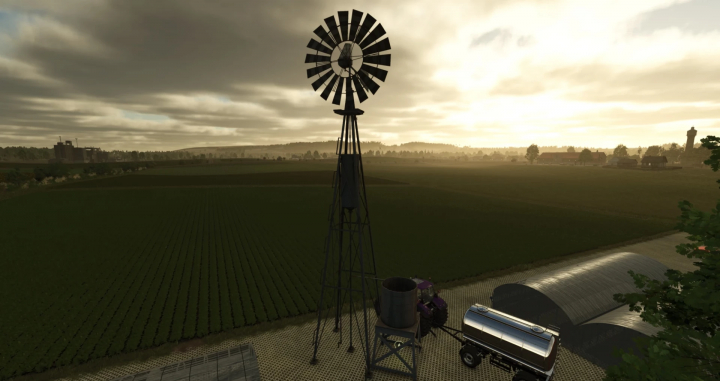 fs25-mods,  FS25-Mod zeigt ein altes Windrad mit Wassertank bei Sonnenaufgang.