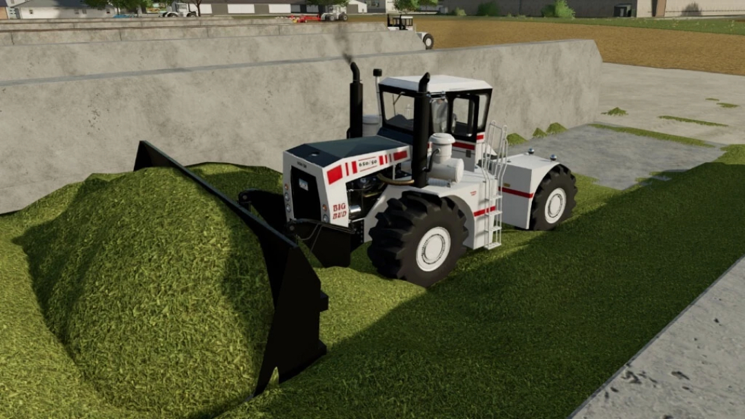 Traktor BigBud S3 v1.0.0.1 mod w FS22 obsługujący kopiec trawy, prezentuje mody Farming Simulator 22.