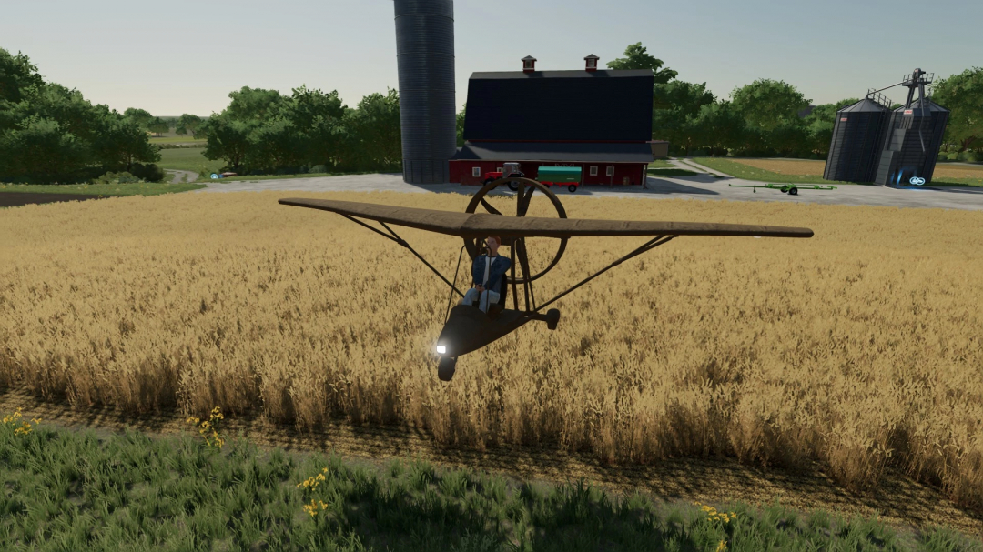 FS22 ULA71084 v1.0.0.0 mod toont een klein vliegtuig boven een tarweveld nabij boerderijgebouwen.